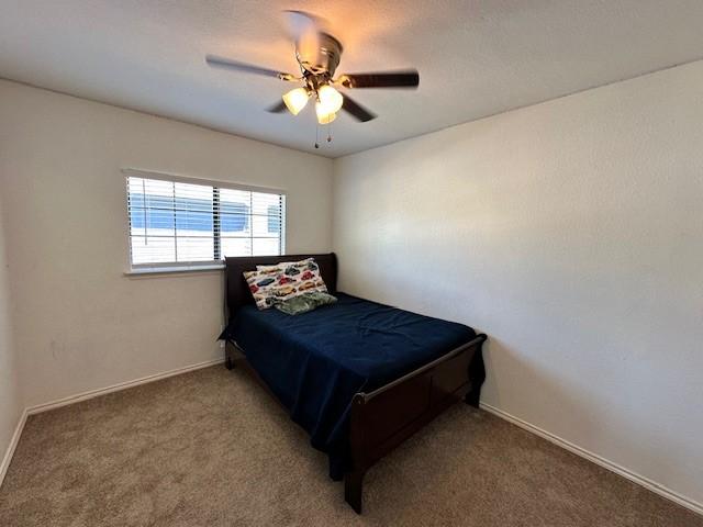 carpeted bedroom with ceiling fan