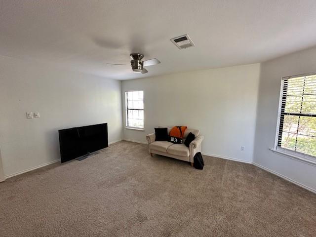 unfurnished room with carpet and ceiling fan