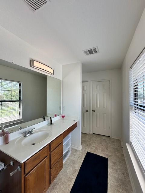 bathroom featuring tile flooring and vanity