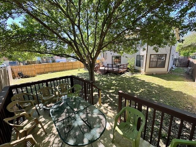 wooden deck with a lawn