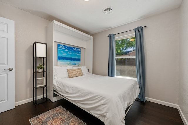 bedroom featuring dark hardwood / wood-style floors