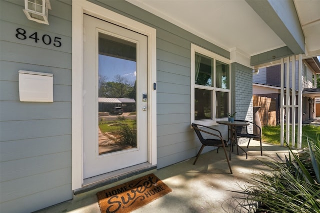 view of exterior entry featuring a porch