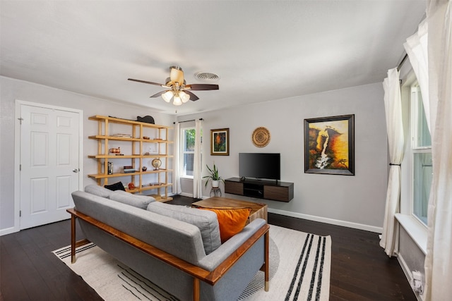 living room with dark hardwood / wood-style floors and ceiling fan