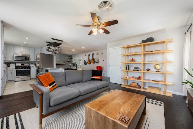 tiled living room with ceiling fan