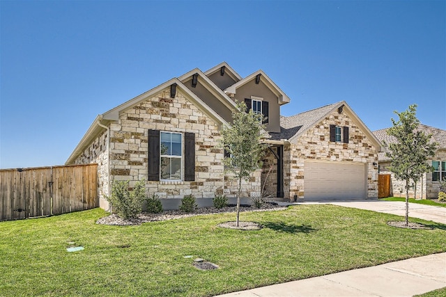 view of front of home with a front yard and a garage