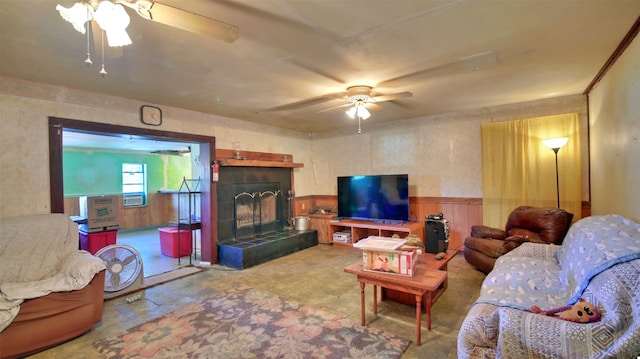 living room featuring ceiling fan and a tile fireplace