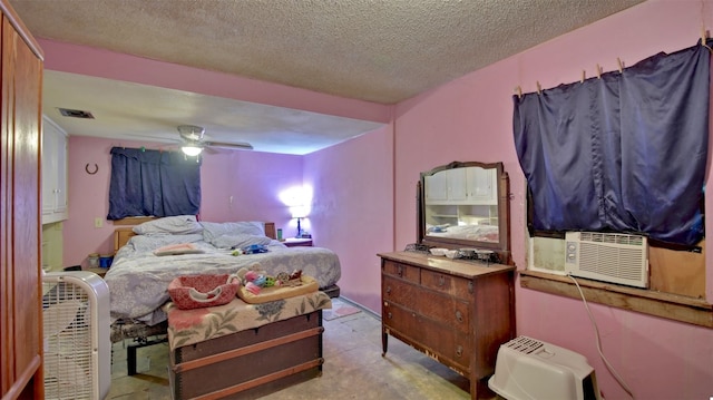 bedroom with ceiling fan, cooling unit, and a textured ceiling