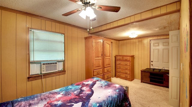 carpeted bedroom with a textured ceiling, ceiling fan, cooling unit, and wood walls