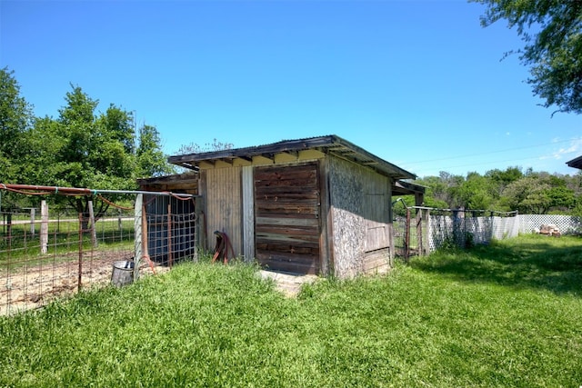 view of outbuilding featuring a lawn