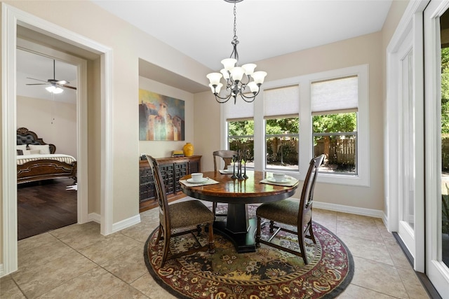 dining area featuring ceiling fan with notable chandelier and light hardwood / wood-style floors