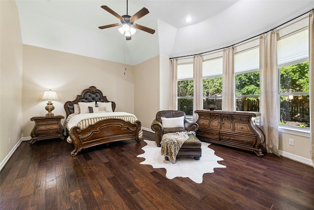 bedroom with ceiling fan, multiple windows, and dark hardwood / wood-style flooring