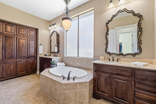 bathroom with a relaxing tiled bath, tile flooring, and dual vanity