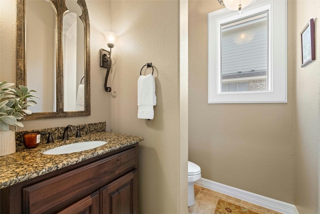 bathroom with toilet, tile flooring, and large vanity