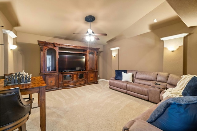 carpeted living room featuring ceiling fan and vaulted ceiling