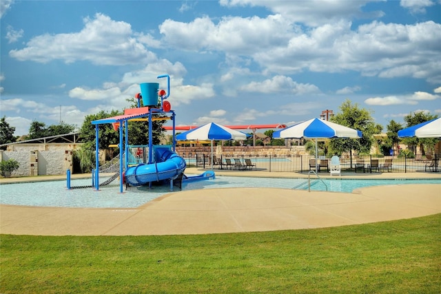 view of jungle gym with a community pool and a yard