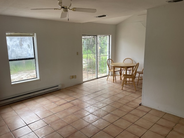 tiled empty room with a baseboard radiator, a healthy amount of sunlight, and ceiling fan