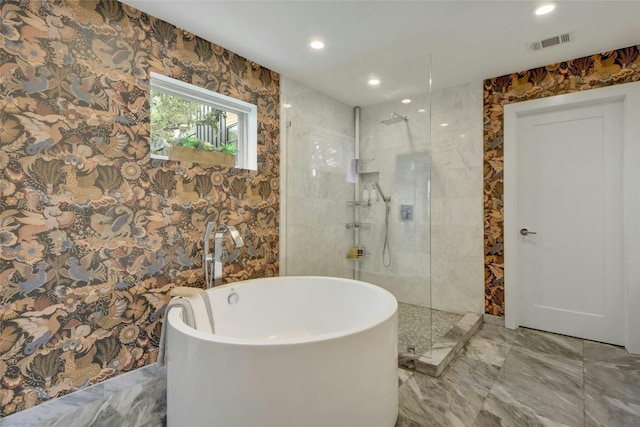 bathroom with marble finish floor, recessed lighting, visible vents, a freestanding bath, and a walk in shower