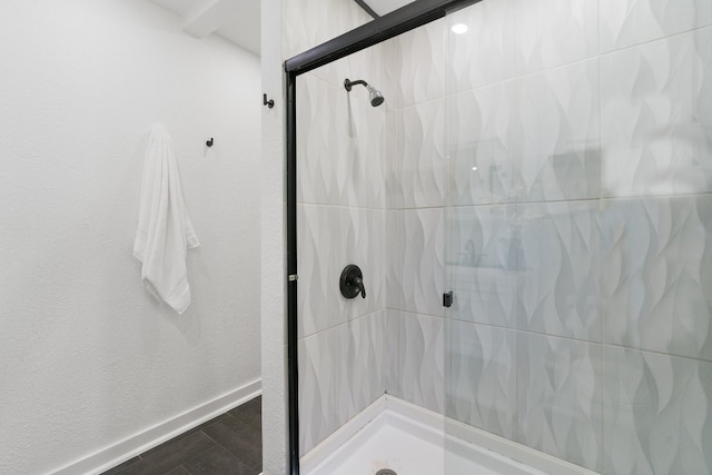 bathroom with tiled shower