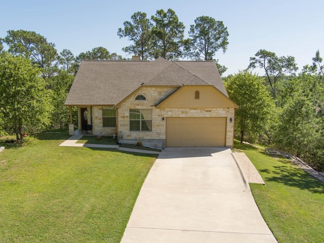 view of front of home with a front yard and a garage