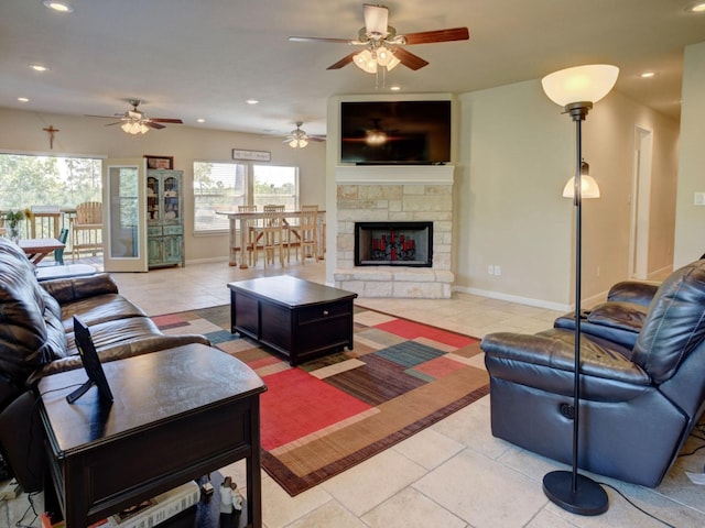 living area featuring recessed lighting, baseboards, and a fireplace