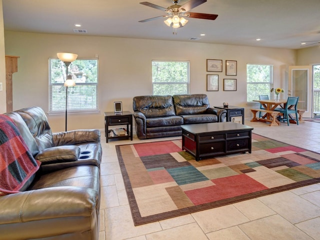 tiled living room with ceiling fan