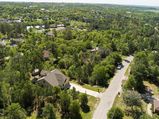 birds eye view of property featuring a forest view