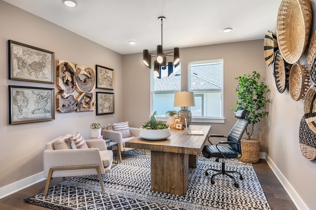 office area with dark hardwood / wood-style flooring and an inviting chandelier