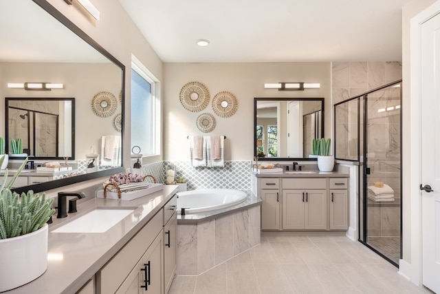 bathroom featuring shower with separate bathtub, vanity, tile patterned floors, and a healthy amount of sunlight