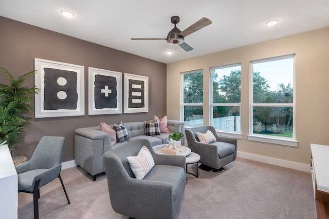 carpeted living room with ceiling fan