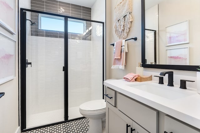 bathroom featuring vanity, toilet, and an enclosed shower