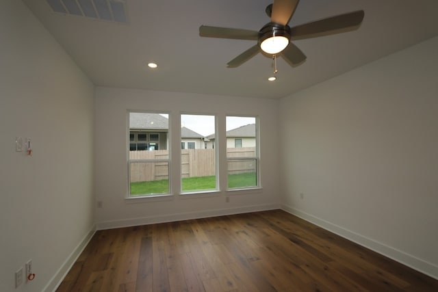 unfurnished room with ceiling fan and dark wood-type flooring