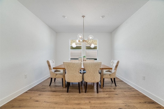 dining area featuring a chandelier and hardwood / wood-style floors