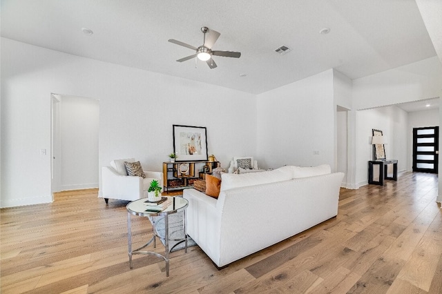 living room featuring ceiling fan and light wood-type flooring