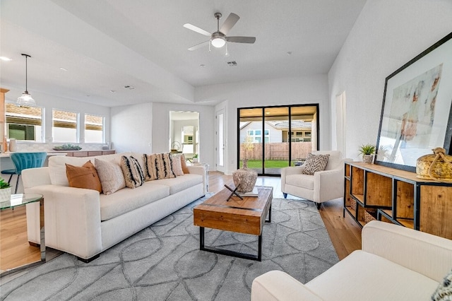 living room featuring plenty of natural light, light hardwood / wood-style floors, and ceiling fan