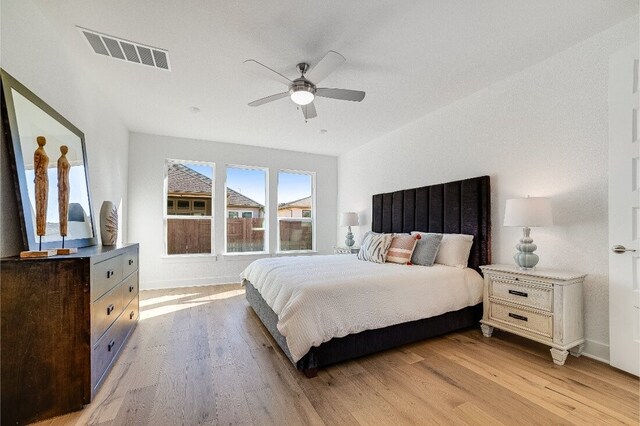 bedroom with ceiling fan and light wood-type flooring