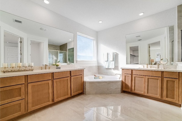 bathroom with vanity and independent shower and bath