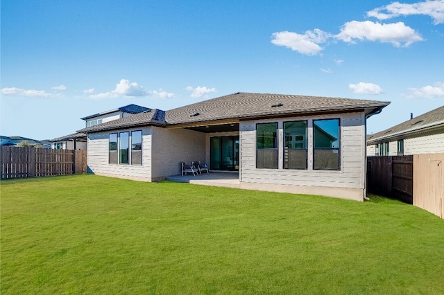 back of property featuring a patio and a lawn