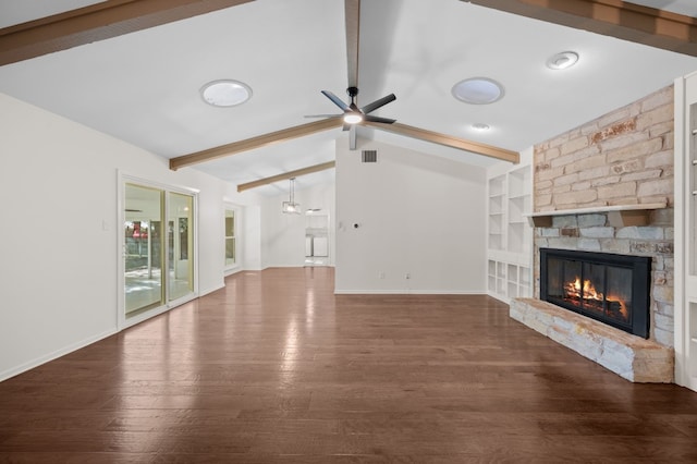 unfurnished living room with ceiling fan, lofted ceiling with beams, built in features, a fireplace, and dark hardwood / wood-style floors