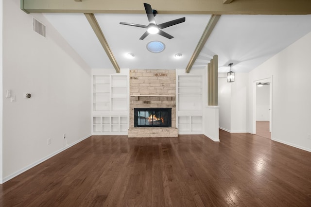 unfurnished living room featuring ceiling fan, lofted ceiling with beams, dark hardwood / wood-style flooring, and a stone fireplace