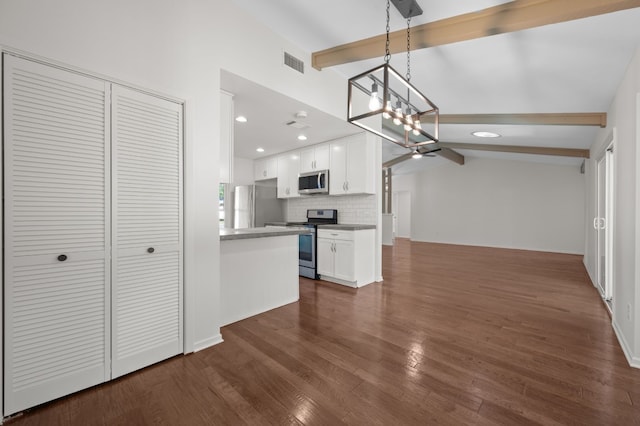 kitchen featuring white cabinets, lofted ceiling with beams, dark hardwood / wood-style floors, and appliances with stainless steel finishes