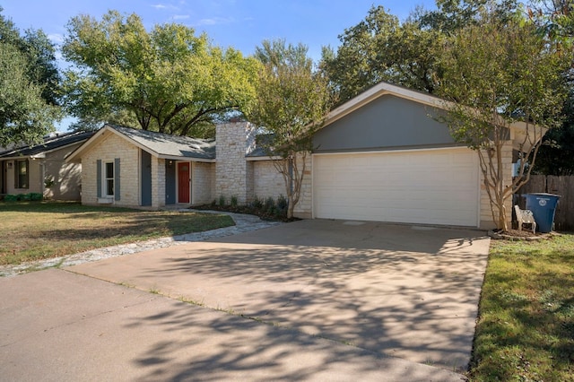 ranch-style home with a garage and a front lawn