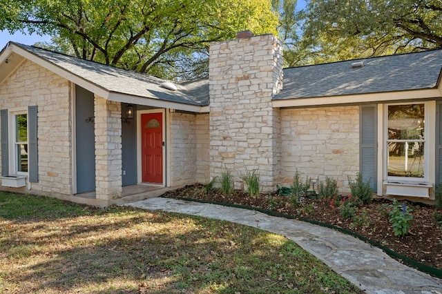 property entrance with a yard