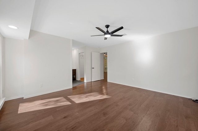 spare room featuring ceiling fan and dark hardwood / wood-style flooring