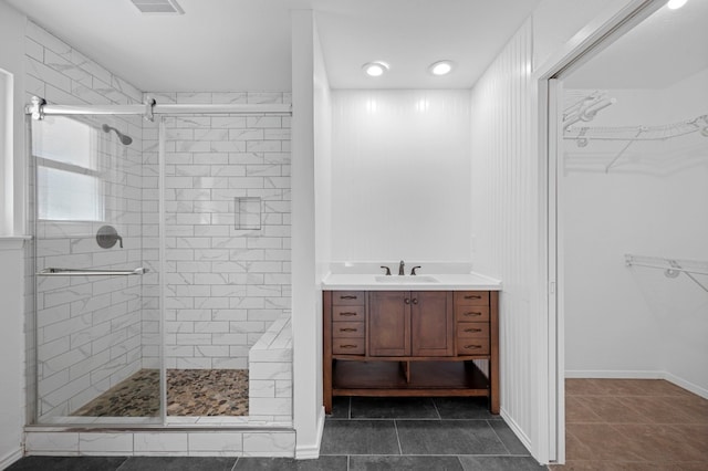 bathroom featuring tile patterned floors, vanity, and a shower with door