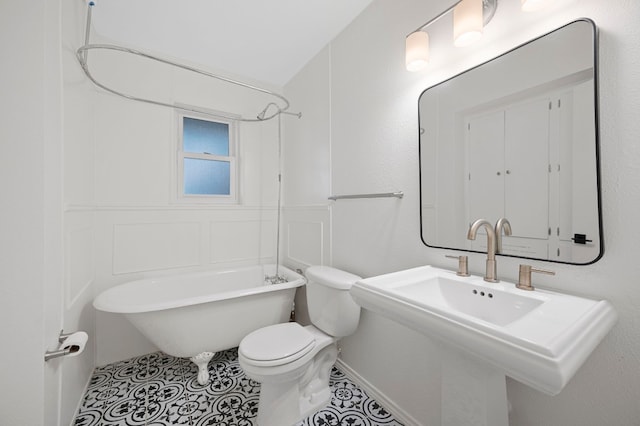 bathroom featuring tile patterned floors, vaulted ceiling, and toilet