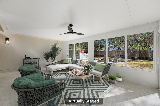 sunroom featuring ceiling fan