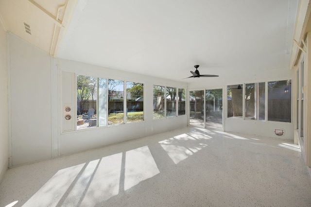 unfurnished sunroom featuring ceiling fan