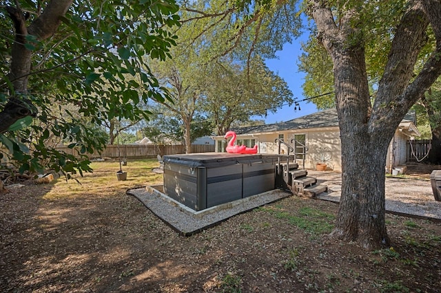 view of yard with a hot tub