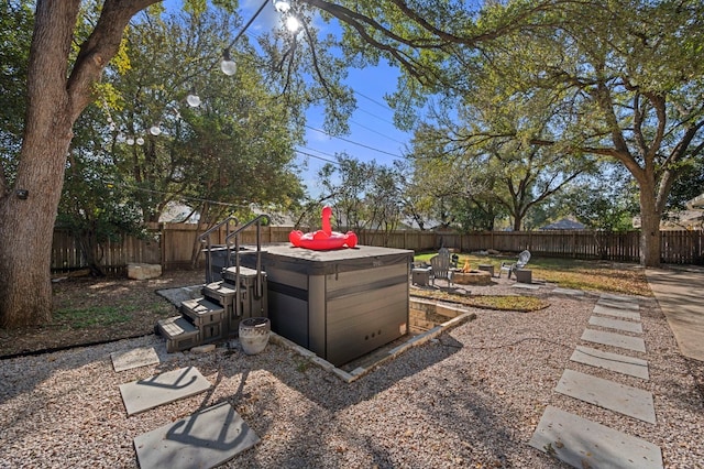 view of yard with a fire pit, a patio area, and a hot tub