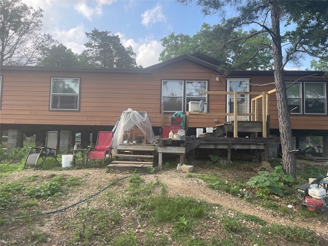 back of house featuring a wooden deck